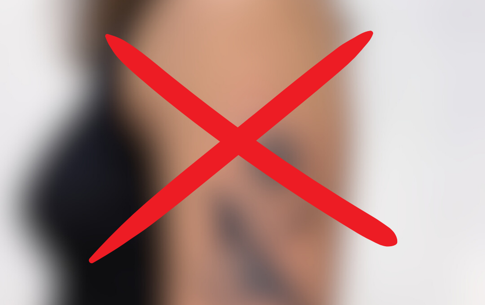 A blurred popular tattoo design marked with a red X, symbolizing a cautionary perspective on permanent body art.