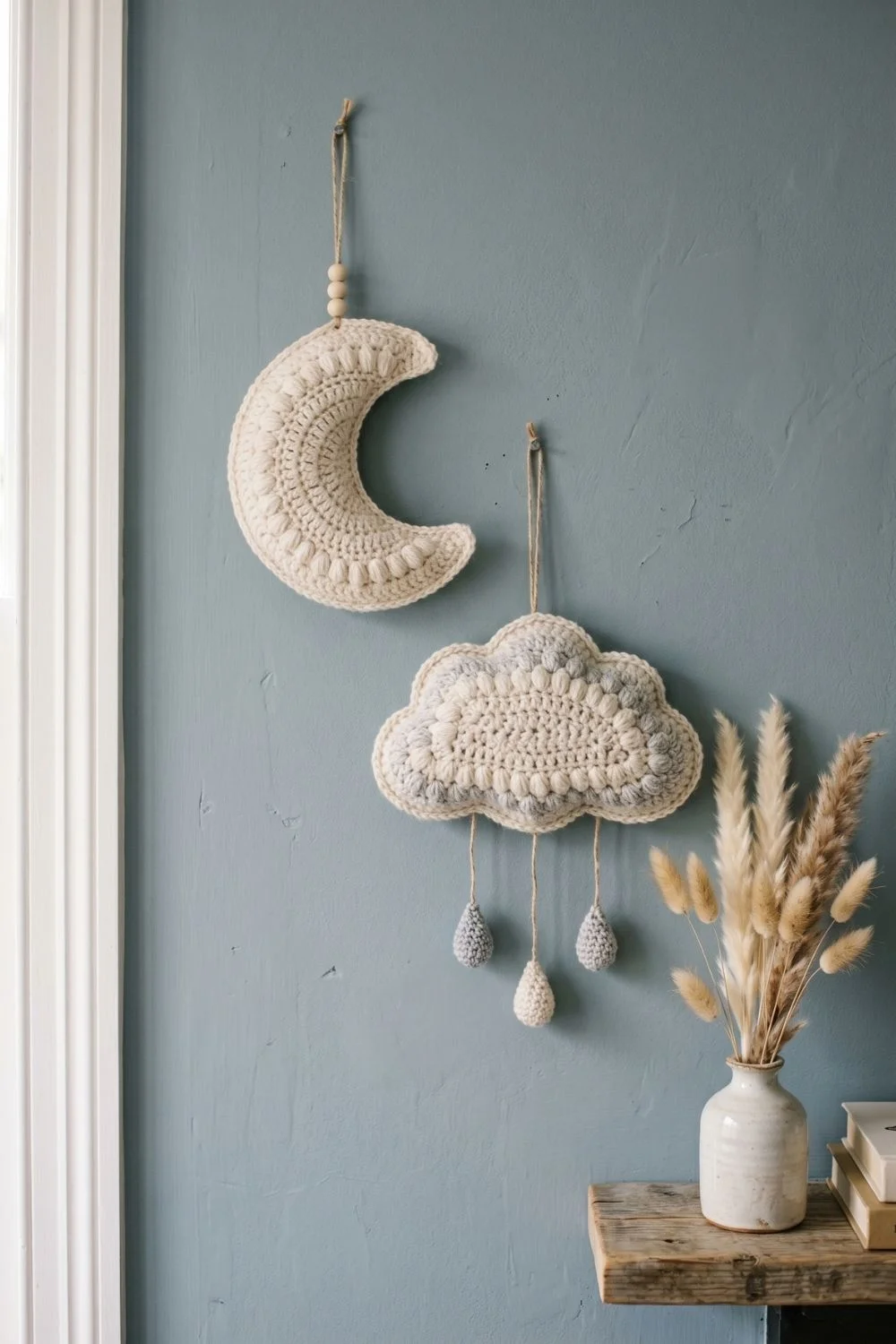8 Crochet Wall Hanging Ideas for a Calm Nursery Corner: Soft Designs Worth Saving 3 Cream and grey crochet cloud and moon wall hangings in a nursery