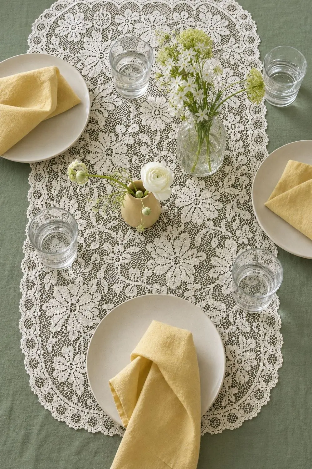 Lace Tablecloths Are Back—But the Fresh Spring Table Trick Is the Layer Underneath 2 Ivory lace tablecloth layered over a soft sage undercloth with spring plates and flowers