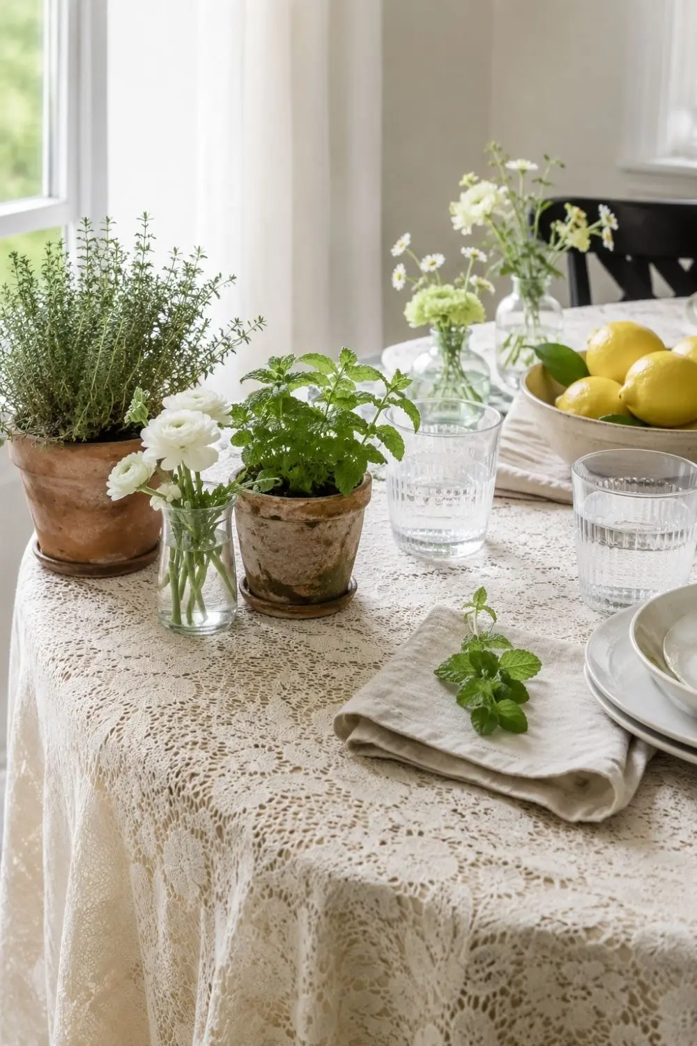 Lace Tablecloths Are Back—But the Fresh Spring Table Trick Is the Layer Underneath 5 Spring table with lace cloth, potted herbs, lemons, water glasses, and flowers kept in small vases