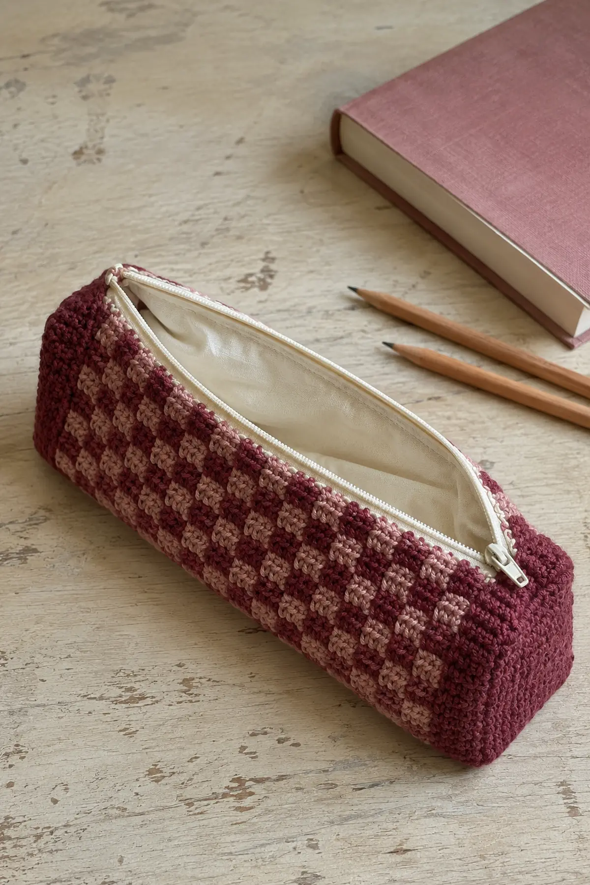 The Crochet Pencil Case Is Back—6 Styles That Are Actually Practical 5 Berry and dusty rose checkerboard crochet pencil pouch with cream zipper and lining
